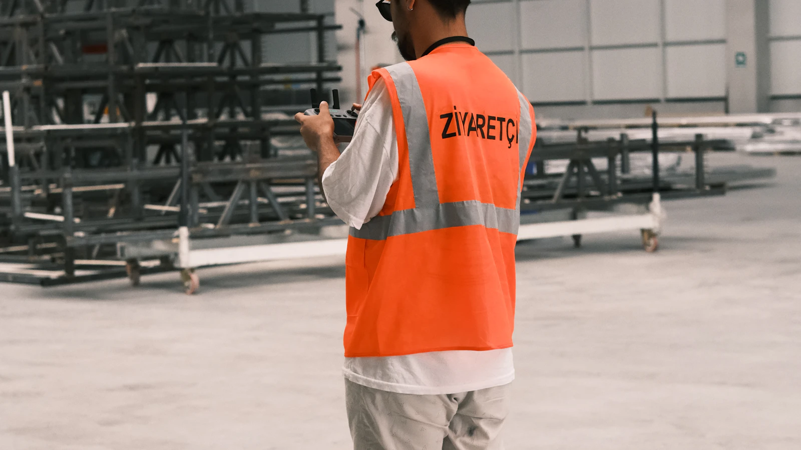 A man wearing a safety vest and a hard hat