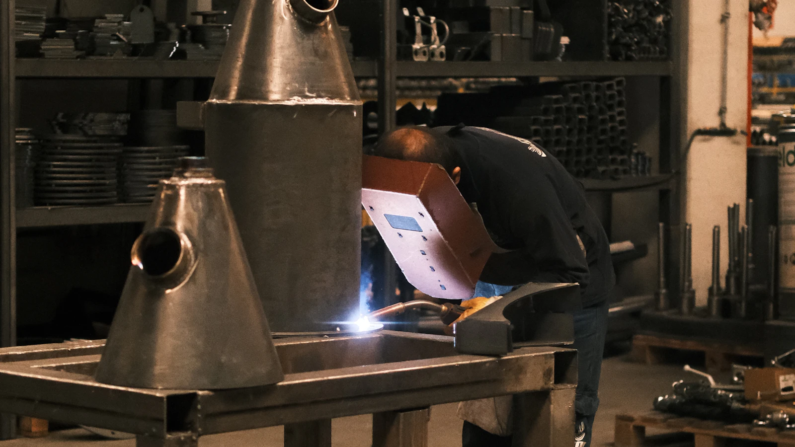 A man working on a piece of equipment in a factory