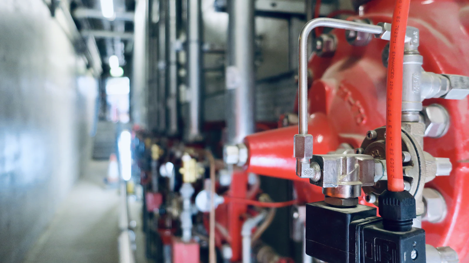 a close up of pipes and valves in a building