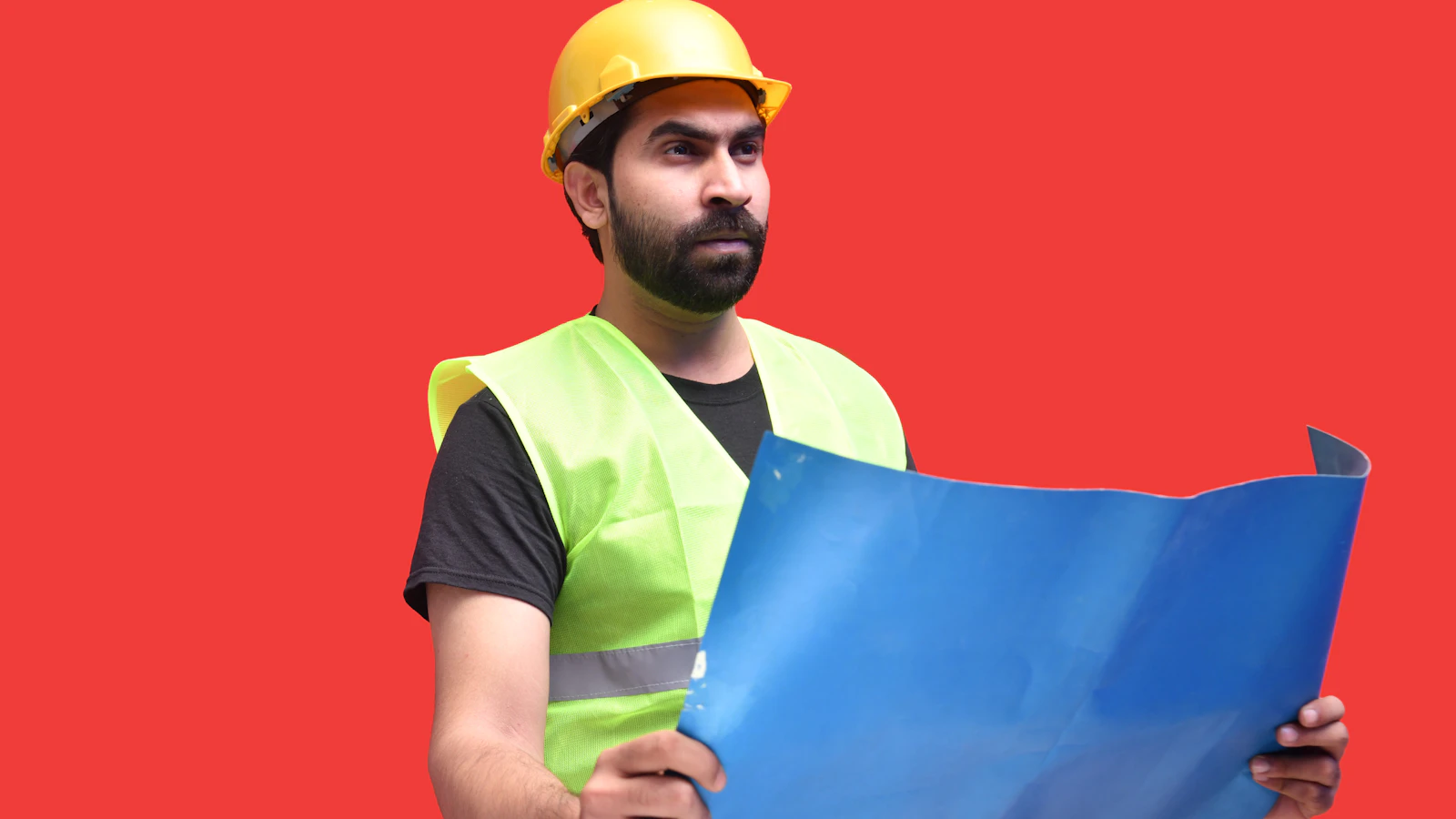 a man wearing a hard hat holding a blue and yellow flag