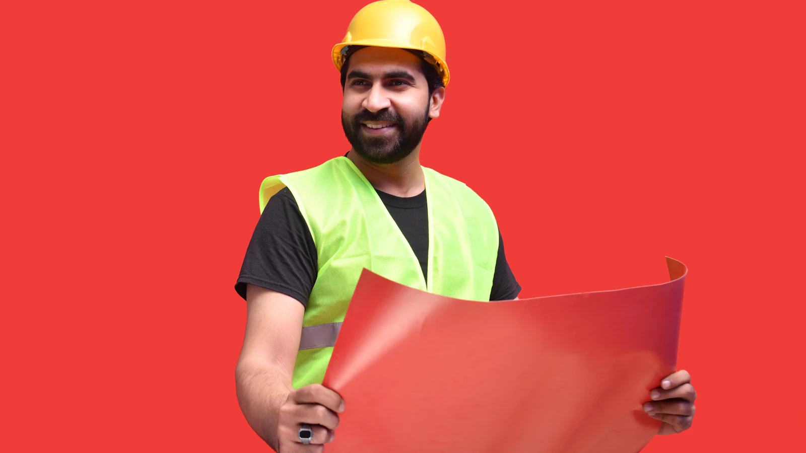 a person wearing a hard hat holding a red folder