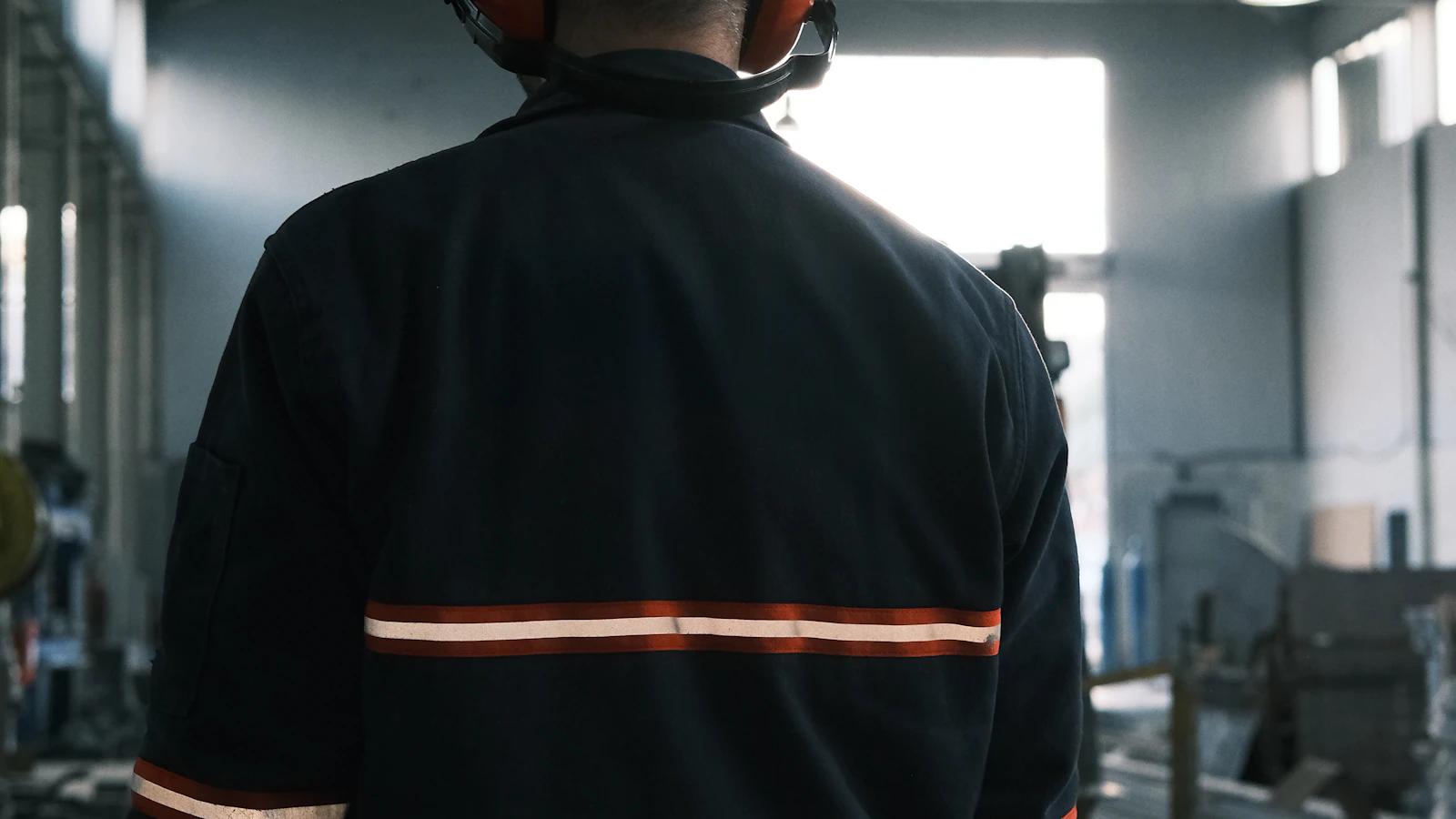 A man in a factory wearing a hard hat