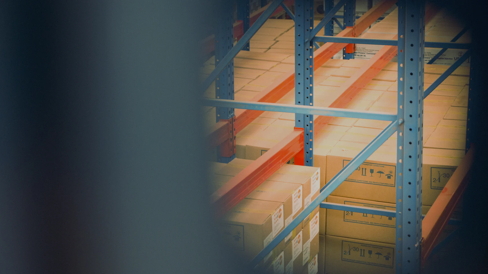 selective focus photography of brown boxes on gray shelf