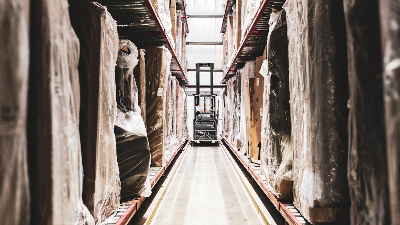 A train track in a large building with statues on it