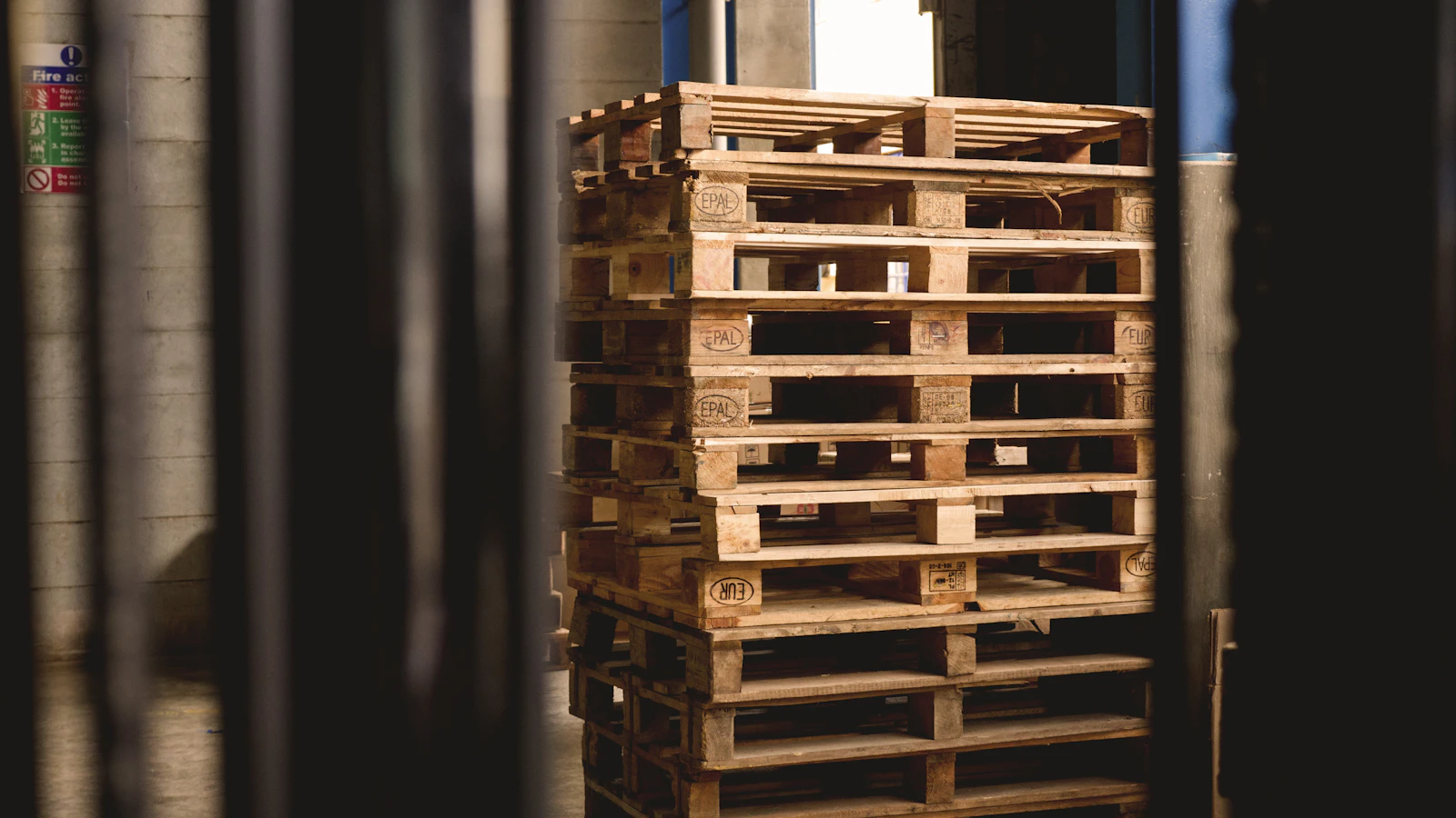 selective focus photography of piled brown wooden pallets