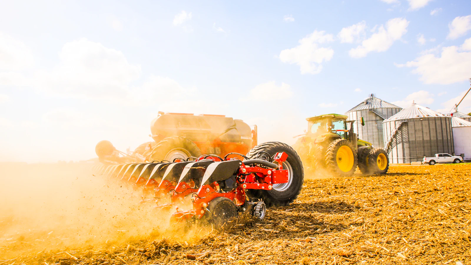 a tractor is driving through a field of hay