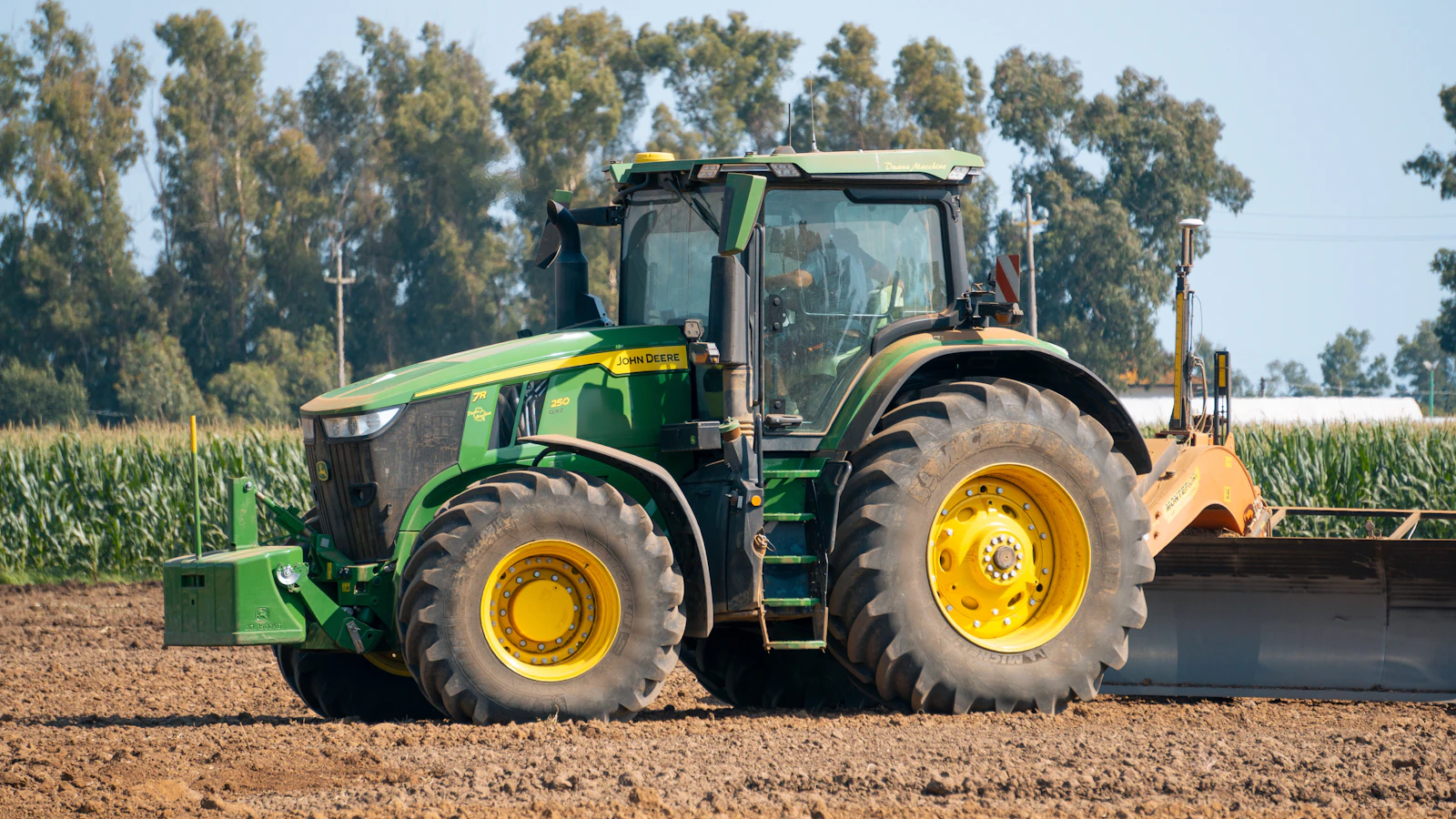 A tractor plowing a field with a plow