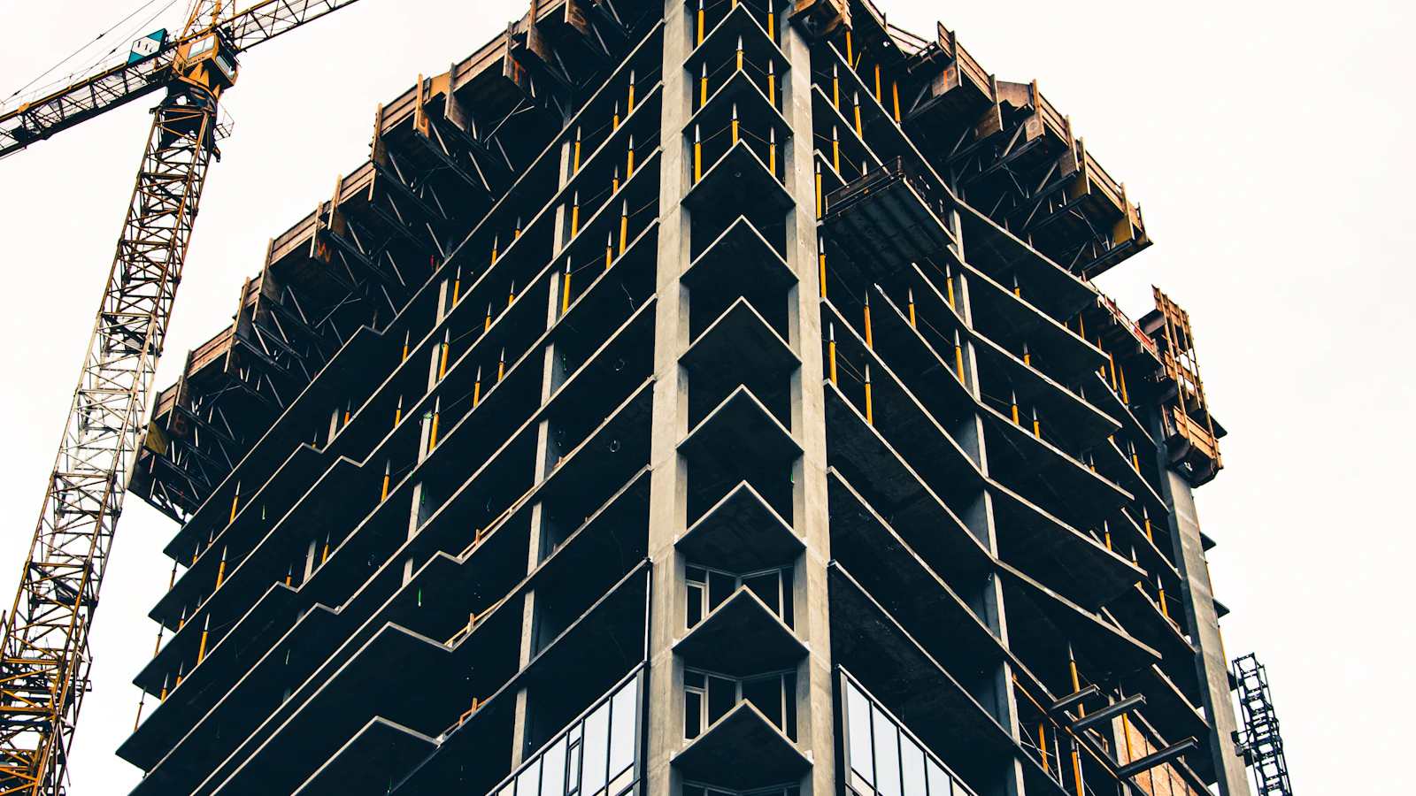 black and white building with yellow crane