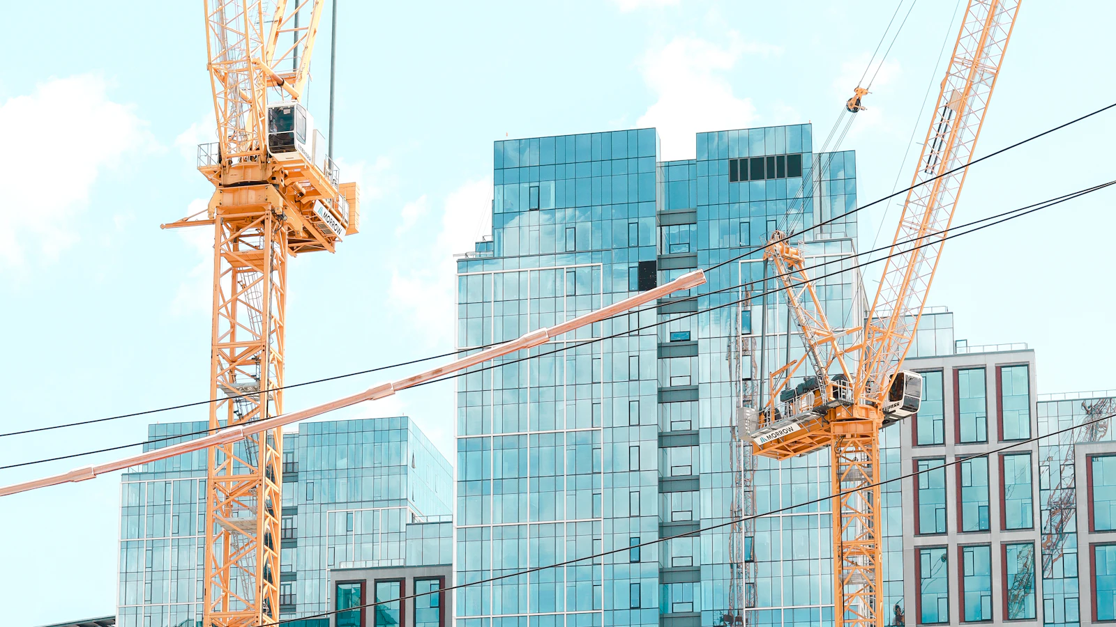 yellow crane near building during daytime