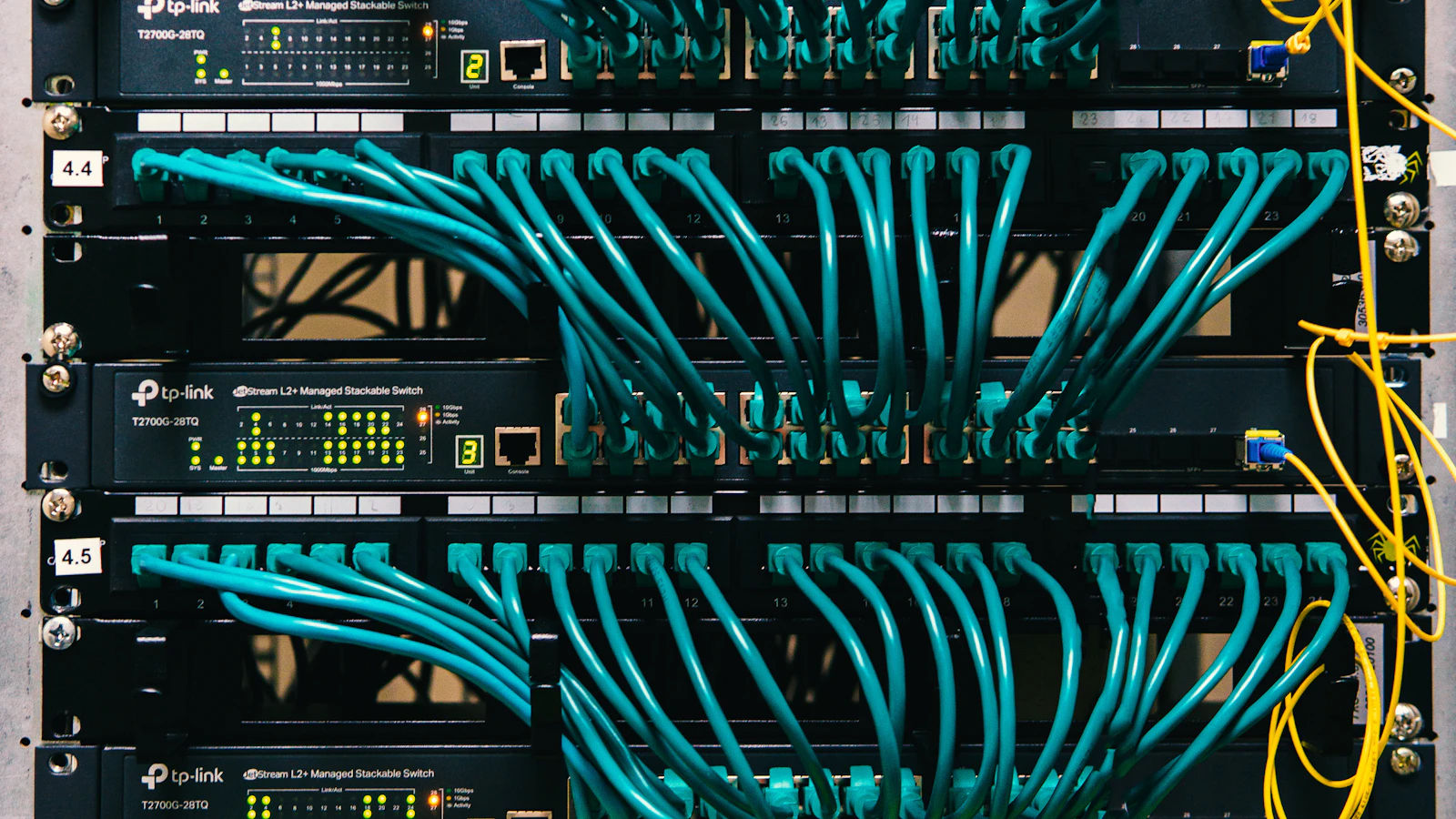a rack of servers with wires and wires attached to them