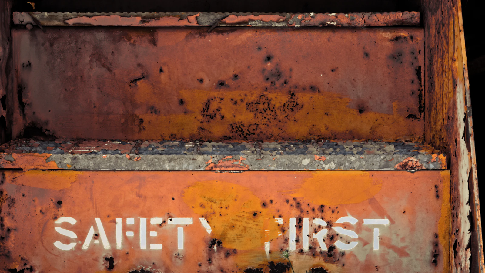 a rusted metal box with writing on it
