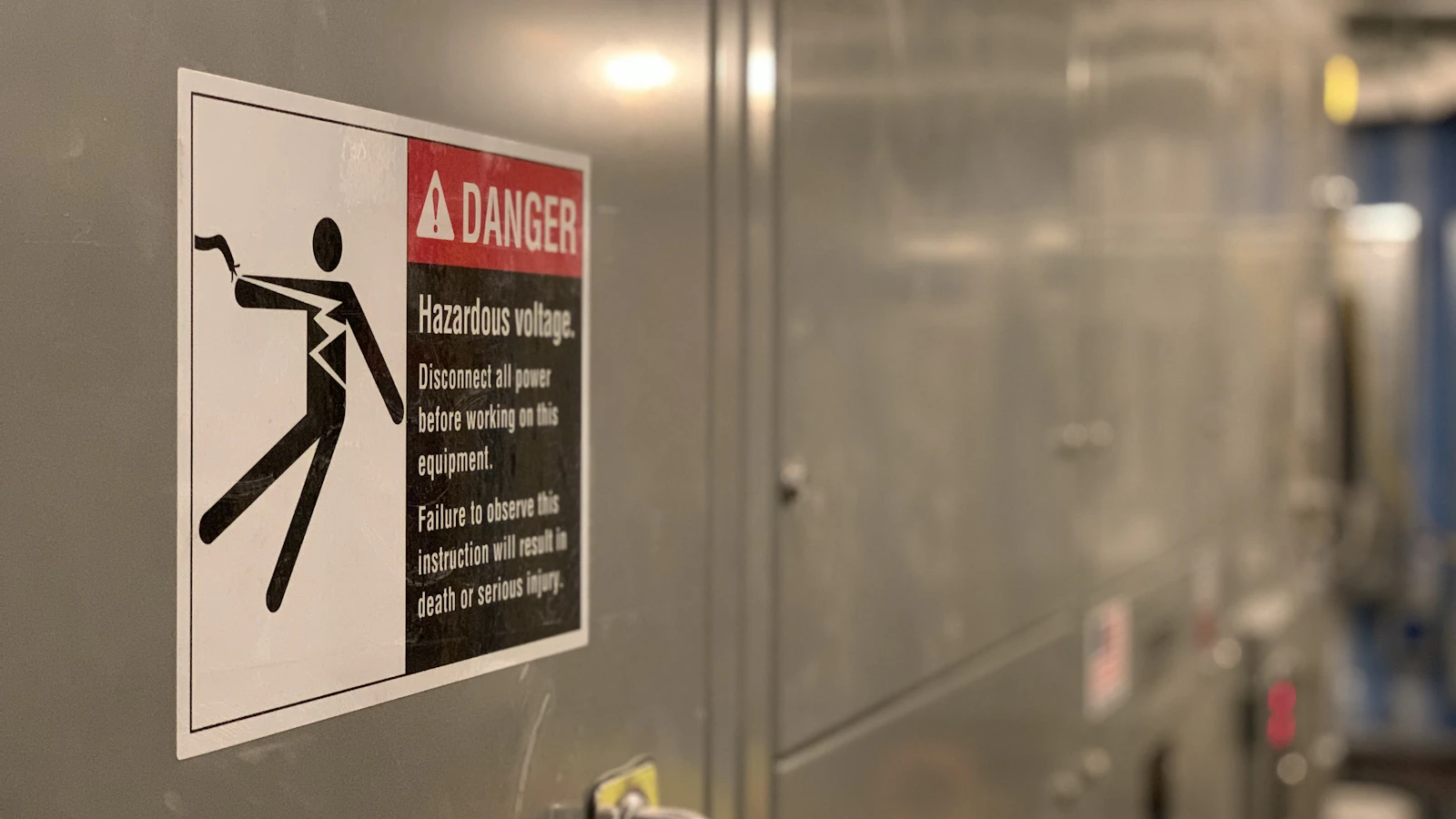 shallow focus photo of high voltage signage