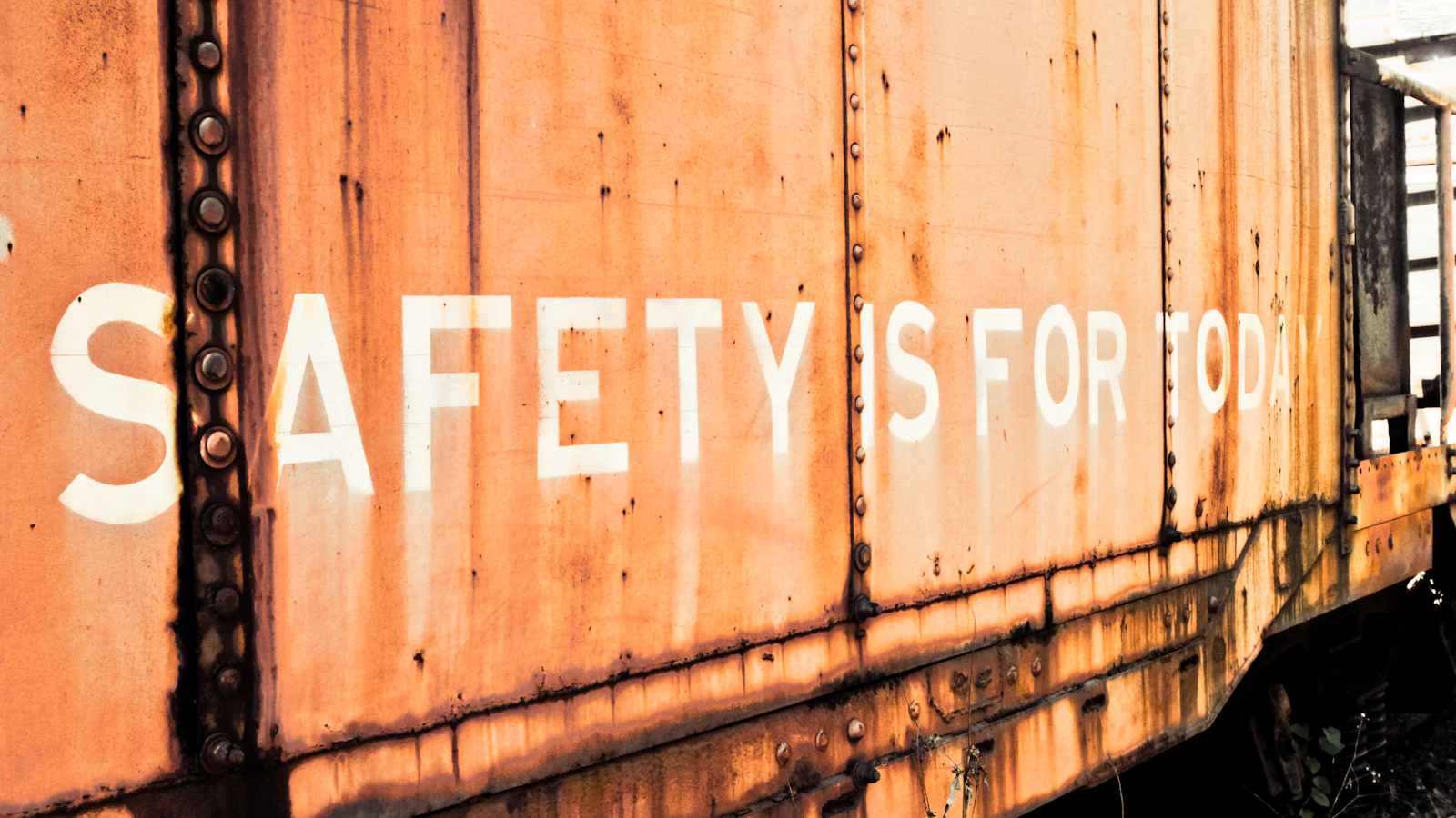 a rusted train car with the words safety is for all