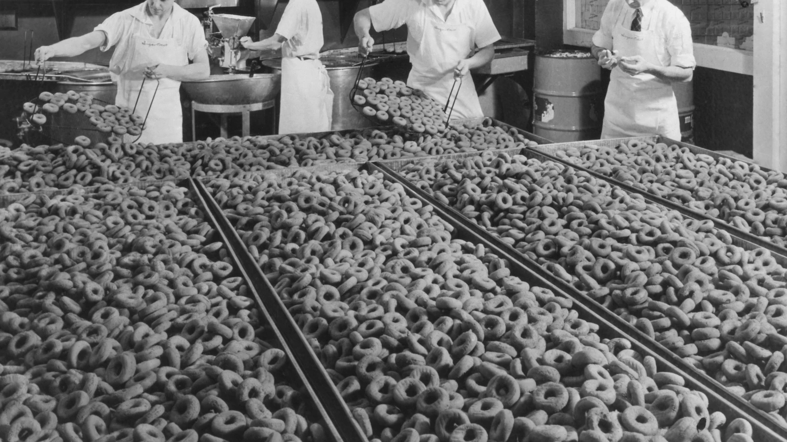 Bakers preparing a massive amount of donuts