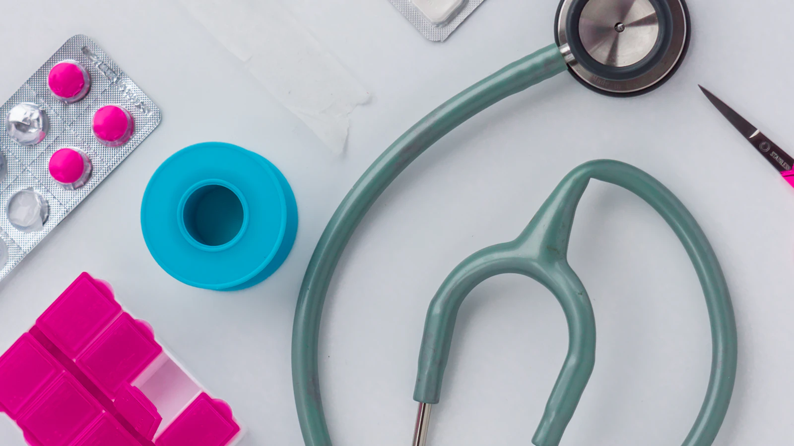 green and silver stethoscope on white envelope