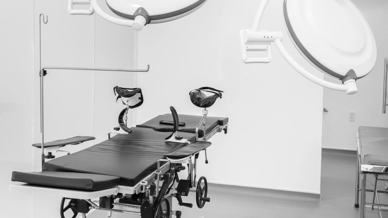 a black and white photo of a hospital room
