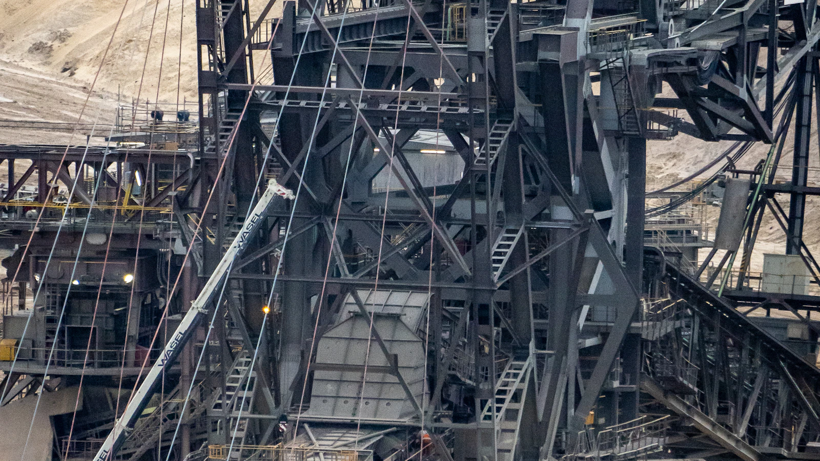 there is a large crane that is in the dirt
