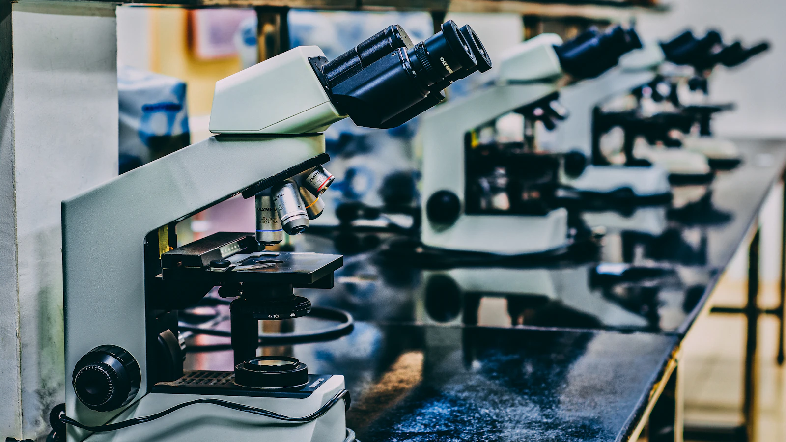 white microscope on top of black table