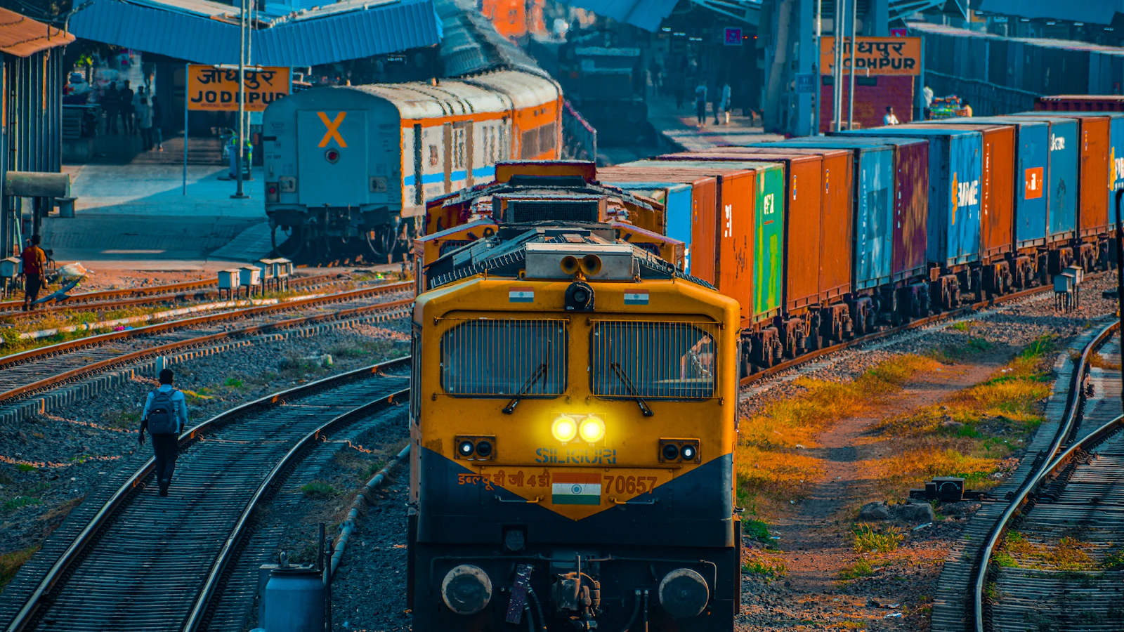 yellow and black train on rail tracks during daytime