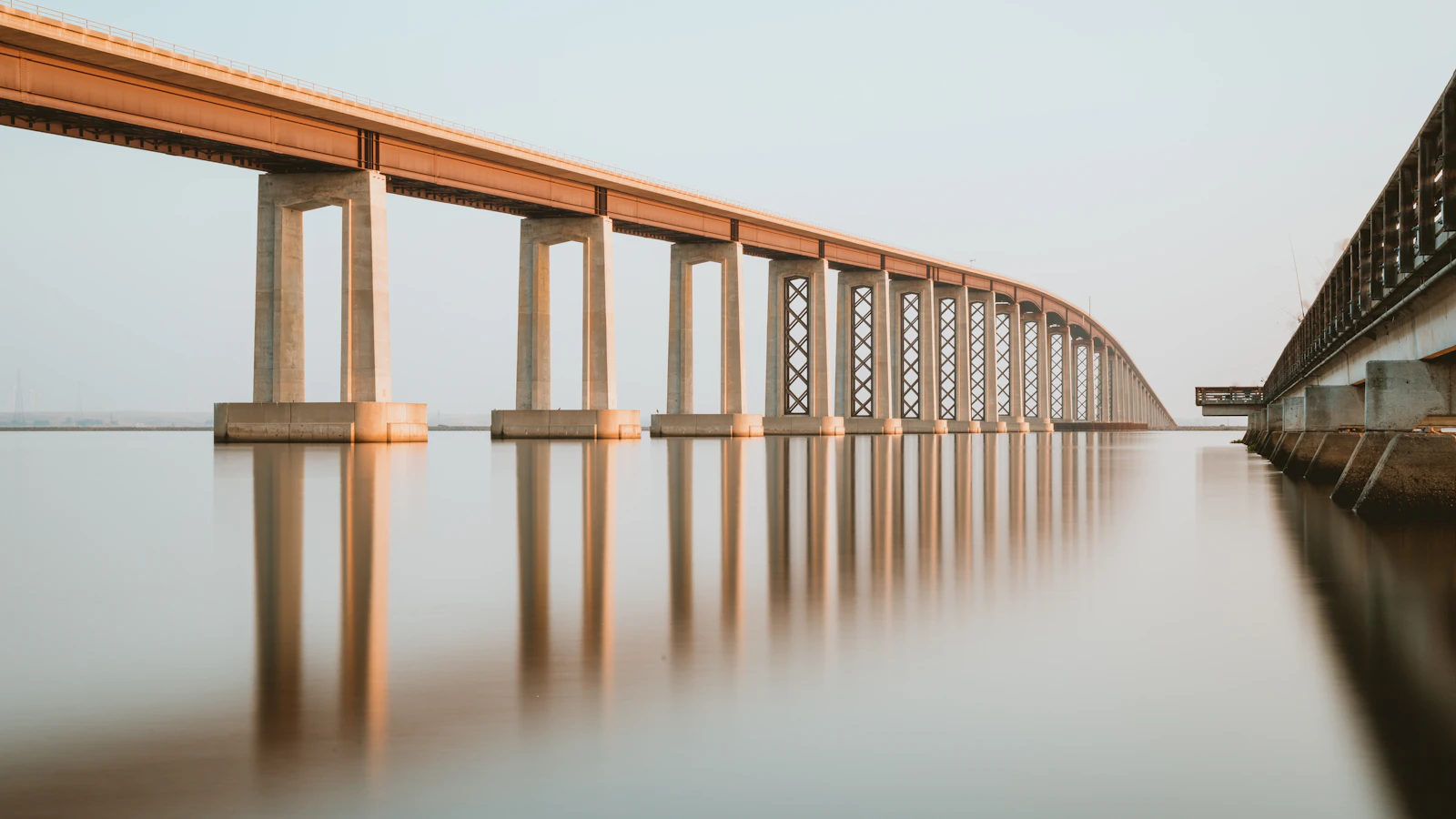 brown wooden bridge over body of water